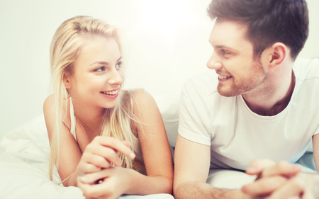 young-couple-talking-in-bed.jpg